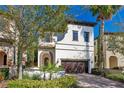 Charming two-story home featuring a terracotta tile roof and a manicured front yard at 8149 Via Vittoria Way, Orlando, FL 32819