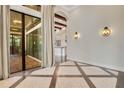 Spacious living room with wood floors, high ceilings, beams, and glass sliding doors leading to outdoor patio at 8149 Via Vittoria Way, Orlando, FL 32819