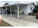 Spacious carport and driveway of a well-maintained single story home in a Florida community at 103 Dreama Dr, Davenport, FL 33897