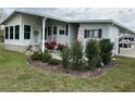 Inviting home entrance with lovely landscaping, seating area and tasteful decor at 103 Dreama Dr, Davenport, FL 33897
