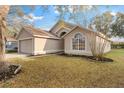 Side view of a single Gathering home with lawn covered in leaves at 113 Glasgow Ct, Davenport, FL 33897