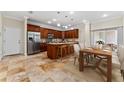 Spacious kitchen features a large island, stainless steel appliances, and a dining area, ideal for entertaining and Gathering meals at 1132 Hardy Ave Ave, Orlando, FL 32803