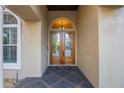 Inviting front entrance with double doors, detailed brickwork, and decorative transom window at 11931 Provincial Way, Windermere, FL 34786