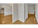 Inviting hallway features hardwood floors, neutral walls, and views into the dining area and kitchen at 1409 Overlake Ave, Orlando, FL 32806