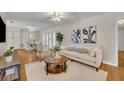 Tastefully furnished living room with hardwood floors, neutral walls, and a view into the dining area at 1409 Overlake Ave, Orlando, FL 32806