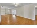 Spacious living room features hardwood floors, sliding glass doors, and neutral wall color at 1409 Overlake Ave, Orlando, FL 32806