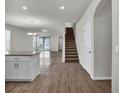 Bright, open-concept living area featuring tile flooring, neutral paint, and an adjacent staircase leading to the upper level at 18058 Cider Mill Ln, Winter Garden, FL 34787