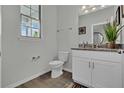 Well-lit bathroom with granite vanity top, stylish fixtures, and a window providing natural light at 18076 Cider Mill Ln, Winter Garden, FL 34787