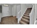 Welcoming entryway leads to carpeted stairs, offering a glimpse of the home's layout and design elements at 18076 Cider Mill Ln, Winter Garden, FL 34787