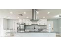 Modern kitchen with stainless steel appliances, granite countertops, and a large island at 1905 Diamond Dr, Orlando, FL 32807