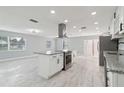 Modern kitchen featuring stainless steel appliances, an island cooktop, and lots of natural light at 1905 Diamond Dr, Orlando, FL 32807