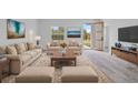 Bright living room featuring stylish furniture, neutral color scheme, and an open doorway at 2436 Sw 155Th Ln, Ocala, FL 34473