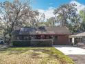 Exterior facade with manicured bushes and brown wood at 26414 Biltmore St, Sorrento, FL 32776