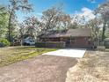 Charming home with concrete driveway and well-kept lawn at 26414 Biltmore St, Sorrento, FL 32776