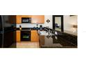 Modern kitchen boasts granite countertops, stainless steel appliances, and ample cabinet space at 3008 Secret Lake Dr, Kissimmee, FL 34747
