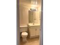 Bathroom featuring a toilet, sink, vanity with doors, mirror, and lighting at 3071 George Mason Ave # A, Winter Park, FL 32792