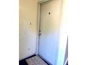 A white interior front door with silver hardware and welcome mat at 3071 George Mason Ave # A, Winter Park, FL 32792