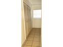 Hallway view with tiled floor, closet with louvered doors, and a window at 3071 George Mason Ave # A, Winter Park, FL 32792