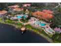 Aerial view showcases the community clubhouse, pools, and the lake at 3154 Yellow Lantana Ln, Kissimmee, FL 34747