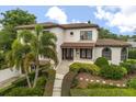Beautiful two-story home with a tile roof, manicured landscaping, and an inviting walkway at 3308 Middlesex Rd, Orlando, FL 32803