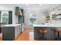 Bright kitchen featuring custom cabinets, stainless appliances, and stylish wallpaper at 3308 Middlesex Rd, Orlando, FL 32803