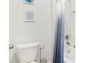 Clean bathroom with white tiled shower and blue ombre curtain at 4589 Boxwood Way, Mount Dora, FL 32757