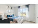Bright bedroom with a large window and blue accents at 4589 Boxwood Way, Mount Dora, FL 32757