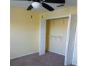 Bedroom with an open closet offering ample storage space, enhanced by neutral walls and carpet flooring at 5455 Vineland Rd # 3303, Orlando, FL 32811