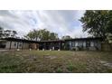 Single-story home featuring a convenient carport and a cozy front porch at 5616 Clearview Dr, Orlando, FL 32819