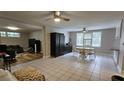 Open living room with tile floors, neutral walls, and modern ceiling fans at 5616 Clearview Dr, Orlando, FL 32819