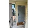 Exterior entryway of unit 5951 with a welcome mat and gray front door at 5951 Village Cir # Ge, Orlando, FL 32822