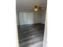 Living room featuring vinyl wood flooring, a ceiling fan and sliding glass doors at 5951 Village Cir # Ge, Orlando, FL 32822
