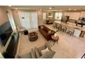 Open-concept living room and kitchen with modern furnishings and tile flooring at 8949 Coconut Breeze Dr, Kissimmee, FL 34747