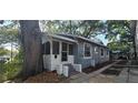 Quaint exterior view of the home, featuring a screened front porch and well-maintained landscaping at 1029 Colyer St, Orlando, FL 32805