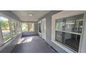 Inviting enclosed front porch with multiple windows, offering plenty of natural light and outdoor views at 1029 Colyer St, Orlando, FL 32805