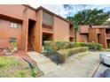 Two-story condo with a private balcony, complemented by a well-manicured lawn at 1038 E Michigan St # B, Orlando, FL 32806