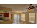 Bright dining area featuring tile floors, modern ceiling fan, and sliding glass doors to private balcony at 1043 S Hiawassee Rd # 3111, Orlando, FL 32835