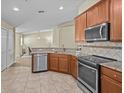 Open-concept kitchen with stainless steel appliances, a breakfast bar, and tile flooring at 1208 Bella Rose Ct, Davenport, FL 33896