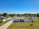 Exterior shot of single-story home, showcasing the manicured lawn, landscaping, and fencing at 12524 Garrett Pl, Grand Island, FL 32735