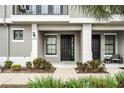 Townhome entrance with well-maintained landscaping at 13042 Michael Callin Aly, Orlando, FL 32828