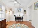 Cozy dining room featuring hardwood floors, a modern ceiling fan, and natural light perfect for Gathering meals at 1632 Pinewood Dr, Orlando, FL 32804