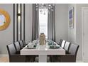 Elegant dining room with modern chandelier and seating for ten at 2217 Lelani Cir, Davenport, FL 33897