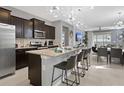 Gourmet kitchen featuring granite countertops, stainless steel appliances, and sleek dark cabinetry at 2217 Lelani Cir, Davenport, FL 33897
