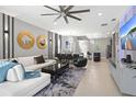 Spacious living room showcasing tile floors, modern furnishings, and elegant decor at 2217 Lelani Cir, Davenport, FL 33897