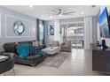 Stylish living room with comfortable seating, neutral tones, and sliding glass doors at 2221 Lelani Cir, Davenport, FL 33897