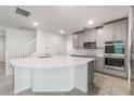 Spacious kitchen featuring a large center island and stainless steel appliances at 2811 Alpine Meadow Ln, Kissimmee, FL 34744