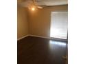 Clean bedroom featuring wood flooring, ceiling fan, and bright window at 315 Wymore Rd # 207, Altamonte Springs, FL 32714