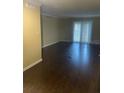 Open living room with dark wood flooring and sliding glass doors at 315 Wymore Rd # 207, Altamonte Springs, FL 32714