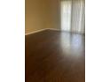 Empty Living room with wood flooring and sliding glass doors at 315 Wymore Rd # 207, Altamonte Springs, FL 32714