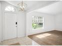 Bright entryway featuring tile, wood floors, natural light, and white interior paint at 3216 Amber St, Deltona, FL 32738